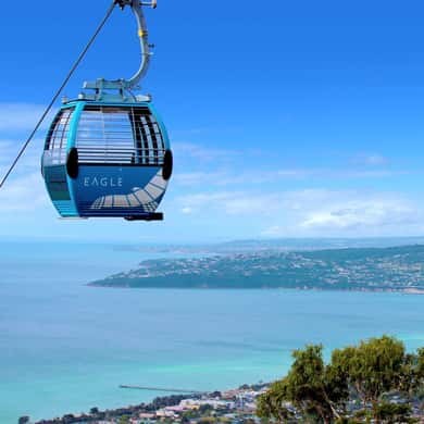 A gondola cabin above the bay on the climb to the summit of Arthurs Seat